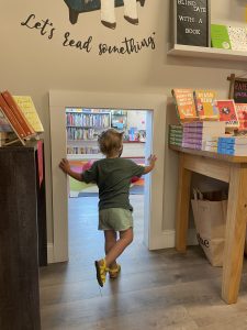 Child at a bookstore on a day out in West Acton, MA