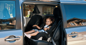 toddler in carseat in minivan