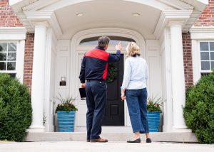 Pest Control Professional and homeowner looking at the front door to keep pests out of your home