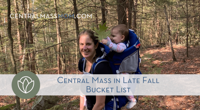Woman Hiking with baby in backpack on Central Mass in Late Fall Bucket List Hike