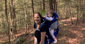 Woman hiking with baby in backpack on central mass in late fall bucket list hike