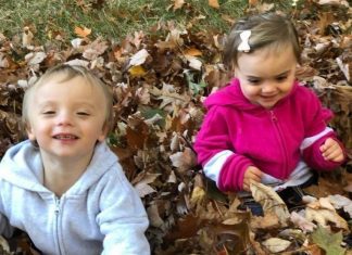 Teaching Toddlers Gratitude title image - toddlers smiling in a pile of leaves