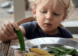 toddler inspecting vegetables