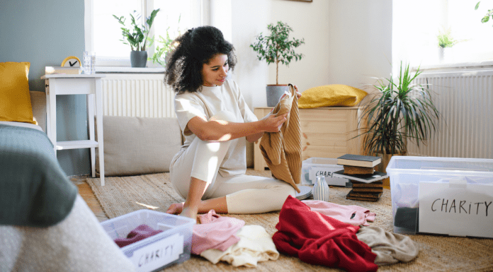 woman sorting through old clothes trying to embody minimalism