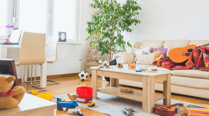 a messy living room with toys and items all over the place