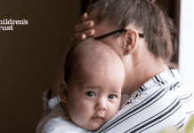 Mom holding an infant managing parenting stress