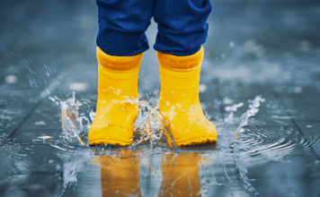 toddler jumping in a puddle, making memories in the little moments