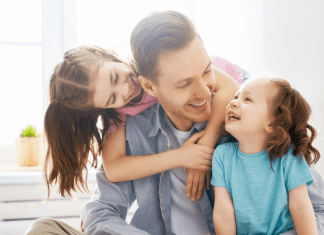 fathers days gift ideas, a father and two daughters laughing and smiling