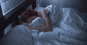 woman sleeping experiencing postpartum depression