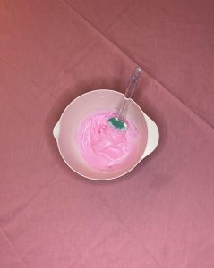 bowl with frosting and pink food coloring for easy valentine's dessert board